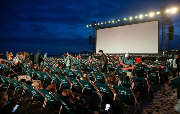 Photo by Zhifei Zhou group of people sitting on raw gray chairs