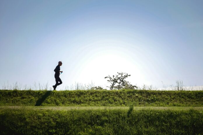 Photo by Marcel Ardivan man in black jacket and pants running on green grass field during daytime